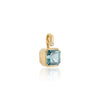 A gold pendant featuring a faceted light blue aquamarine gemstone in a bezel setting with a small round accent stone, shown on a clean white background with a soft reflection.