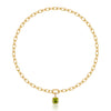 A gold chain necklace with a gold pendant featuring a square-cut green peridot gemstone and a small round diamond accent, shown on a clean white background with a soft reflection below.