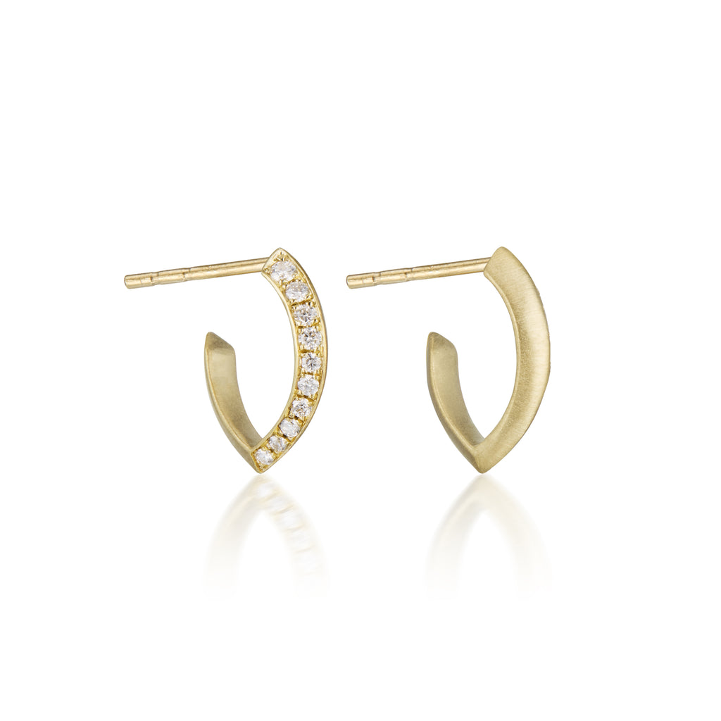 Gold hoop earrings with embedded diamonds on a white background