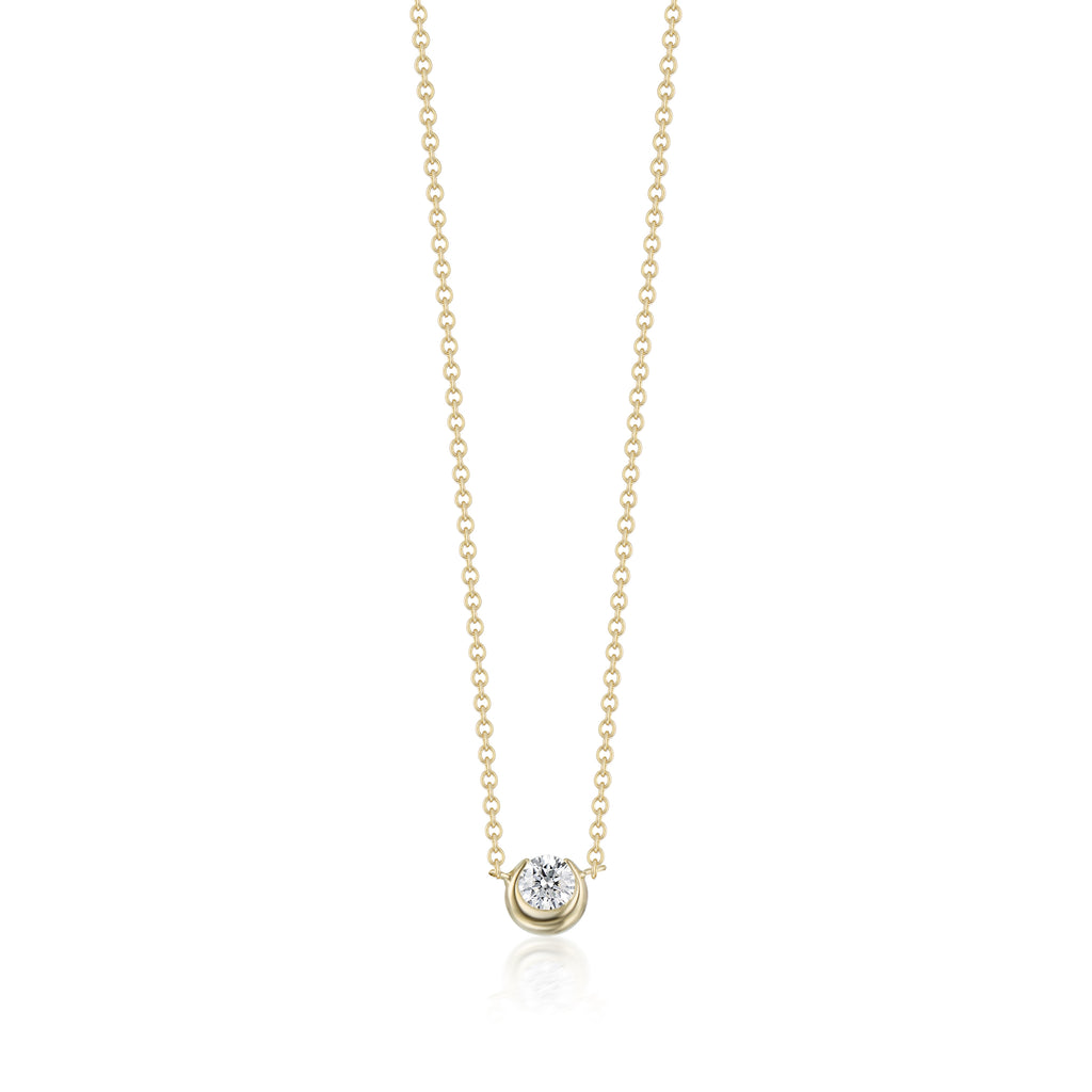 Gold necklace with a small diamond pendant on a white background
