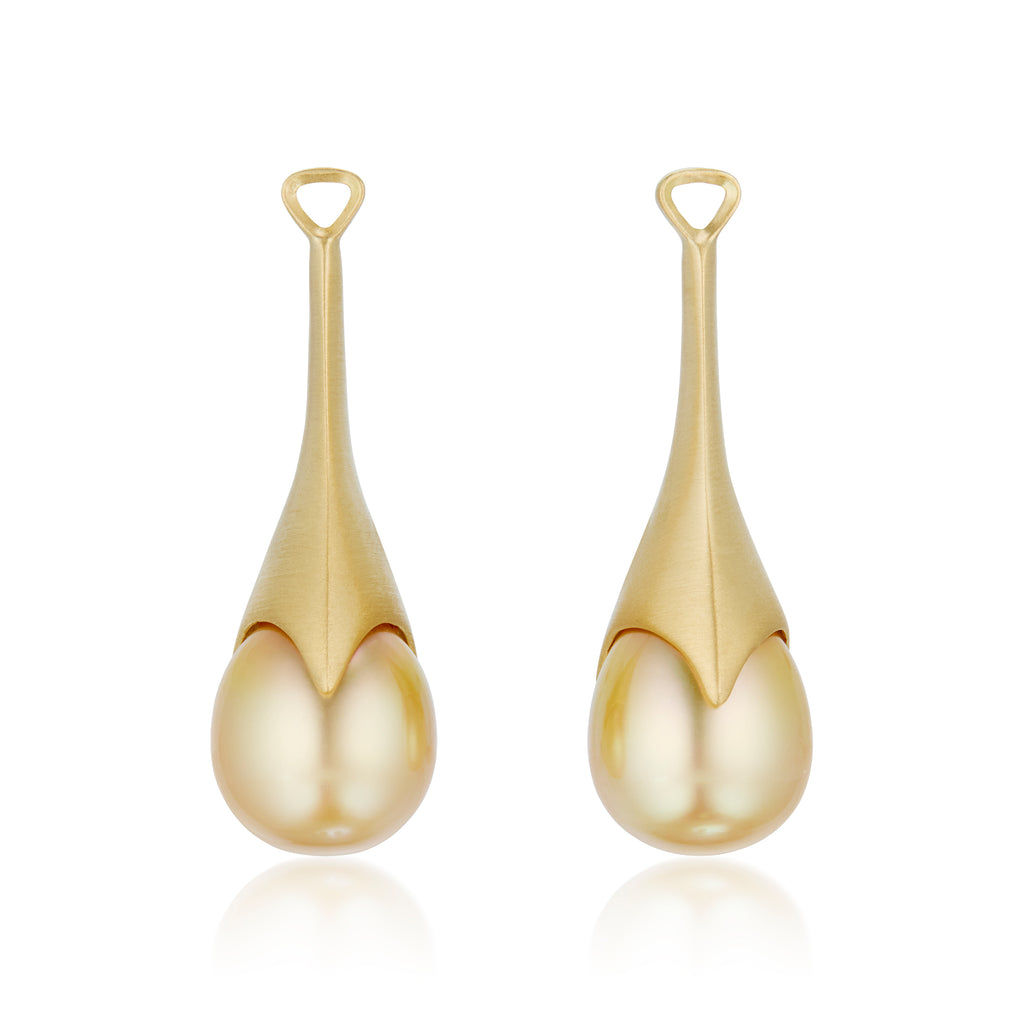 A pair of golden teardrop statement earrings, detachable pearl pendants  shown on a clean white background with a soft reflection below.