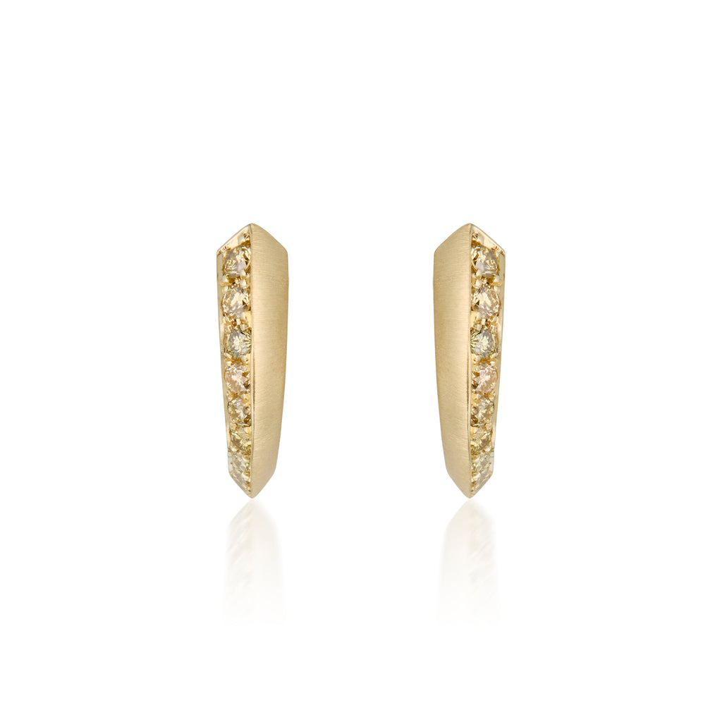 A pair of golden hoop earrings with a row of pavé-set ombre yellow diamond stones along the front edge, shown on a clean white background with a soft reflection below.