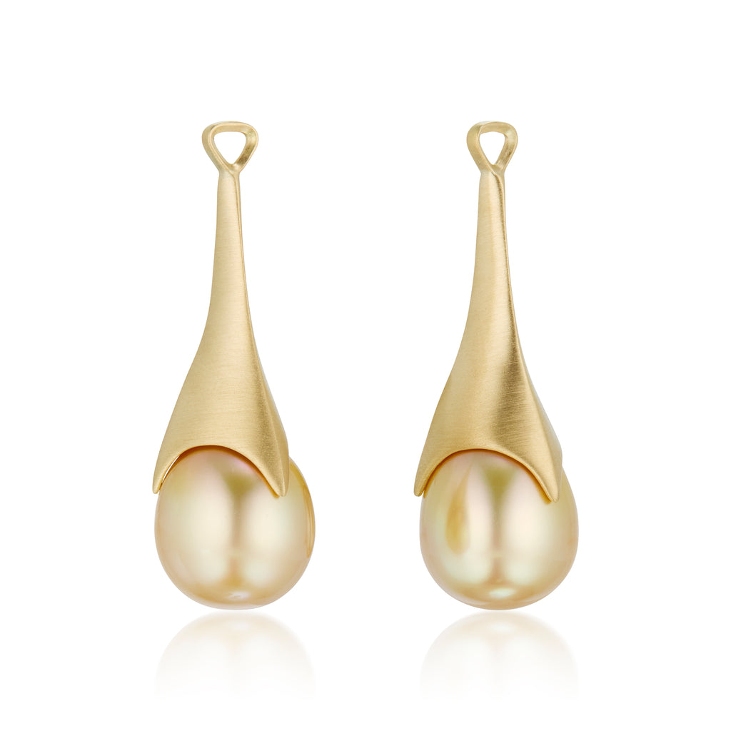 A pair of golden teardrop statement earrings, detachable pearl pendants, shown on a clean white background with a soft reflection below.