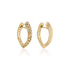 A pair of golden hoop earrings with a row of pavé-set ombre yellow diamond stones along the front edge, shown on a clean white background with a soft reflection below.