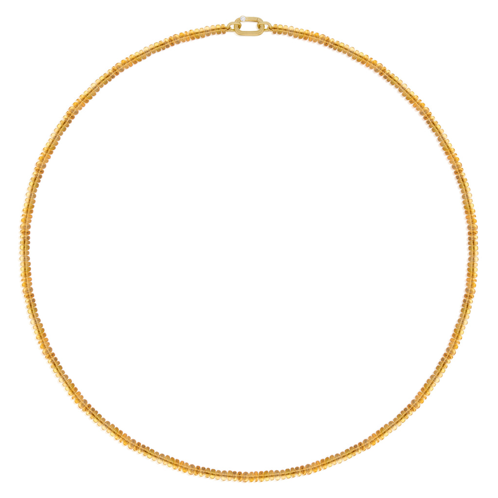 A delicate gold chain necklace composed of tiny smooth beads, orange in color, luminescent, Mexican Fire opal, arranged in a circle on a solid white background.
