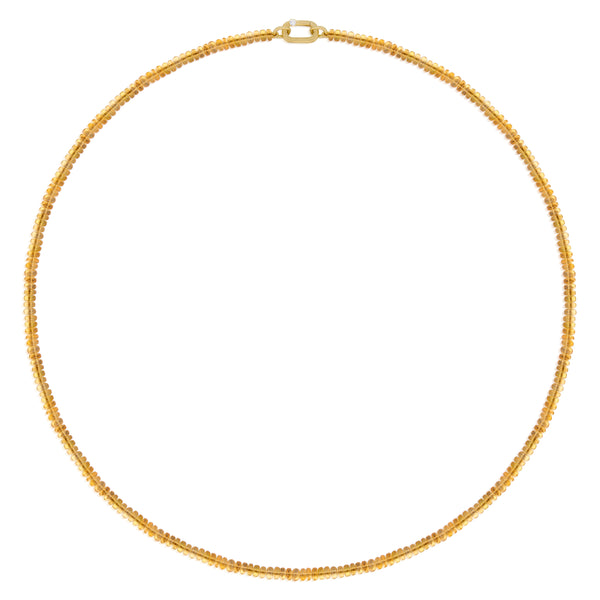 A delicate gold chain necklace composed of tiny smooth beads, orange in color, luminescent, Mexican Fire opal, arranged in a circle on a solid white background.